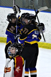 Downingtown East’s Maddie Allen (77) and Carly Kloss (98) celebrate Alexa Weiderhold’s second goal of the game in a 4-3 win over West Chester East on Wednesday Night in the Flyers Cup Girls semifinal. (Candice Monhollan)